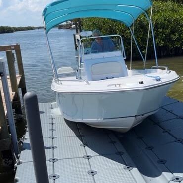 boat docking on floating Gulf Stream Dock